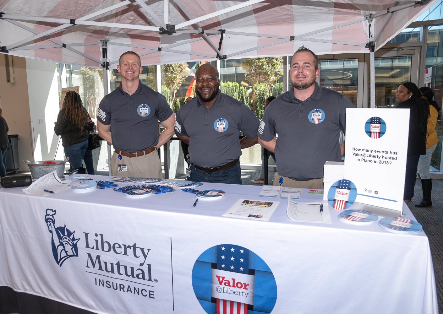 Personnel standing behind a table