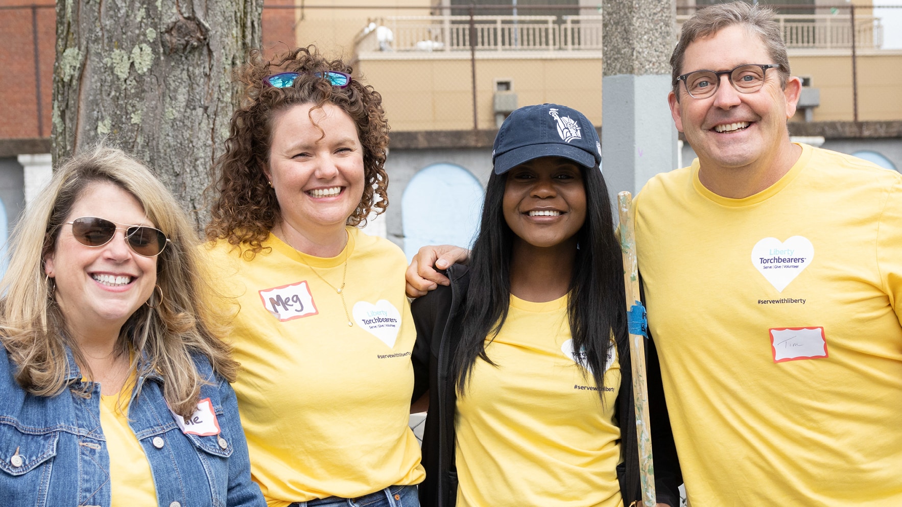 Liberty Mutual employees - including CEO Tim Sweeney - at Serve with Liberty, smiling to camera