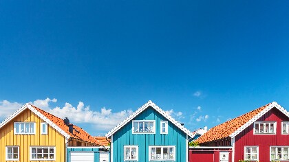 Exterior shot of a line of homes, in primary colors 