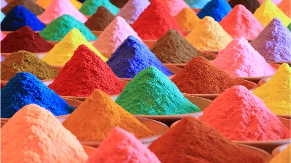 Mounds of different color herbs and spices 