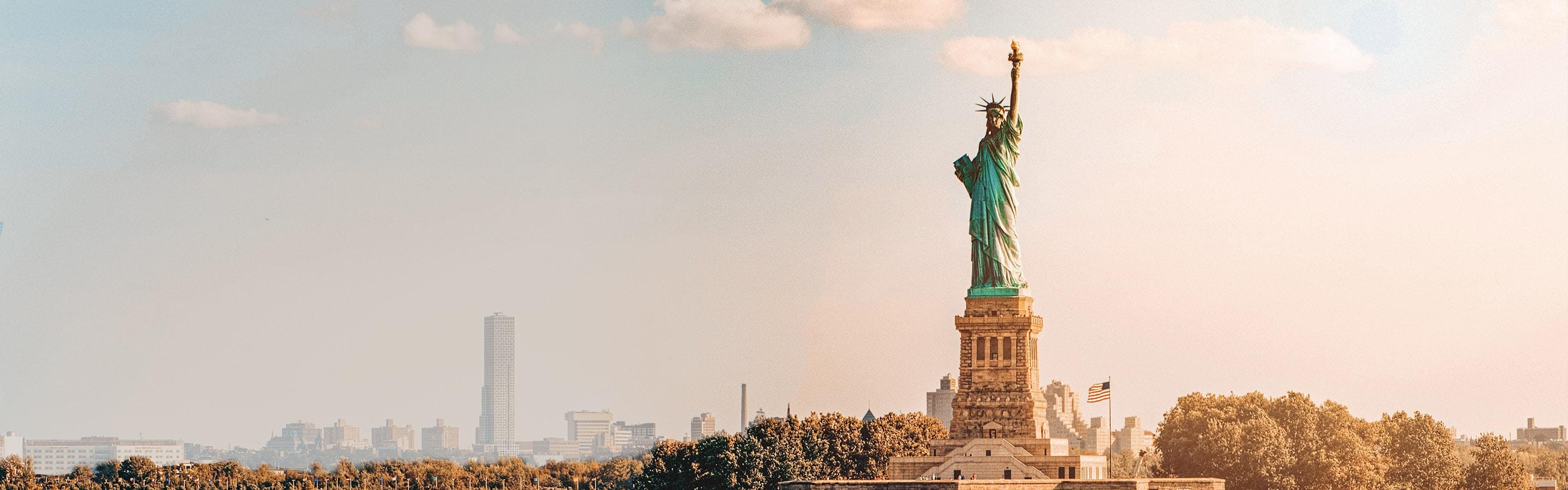 Longshot of The Statue of Liberty, with New York slightly in the background/distance