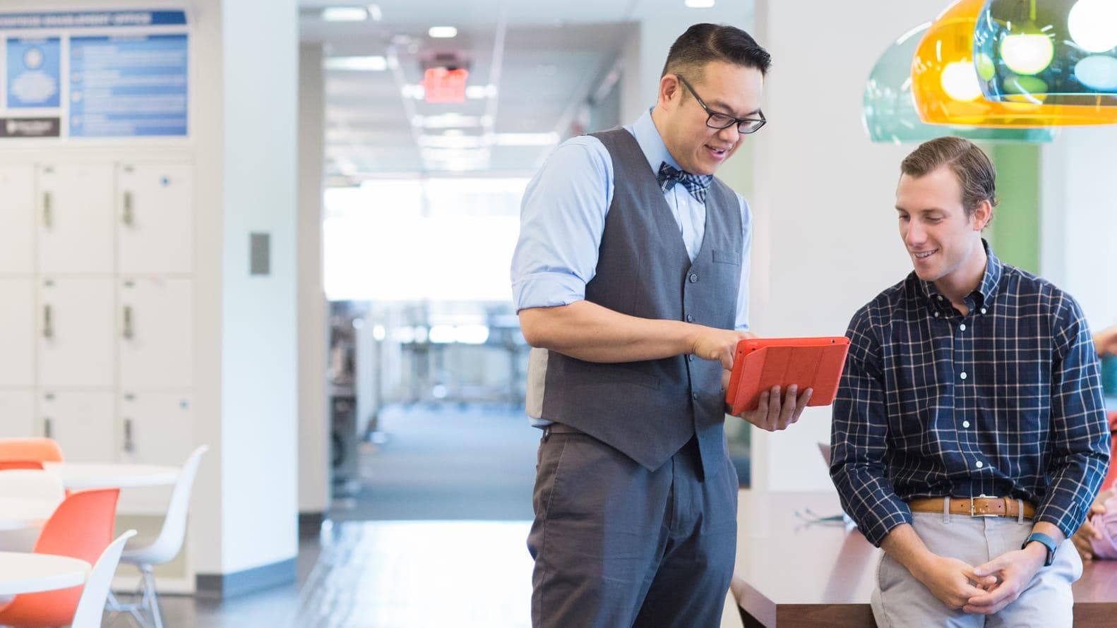 Two male employees talking about work