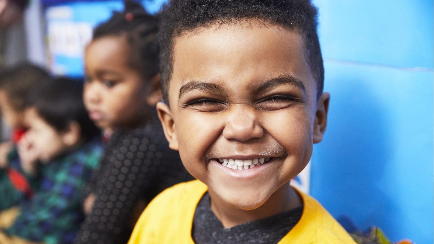 Young boy smiling at the camera