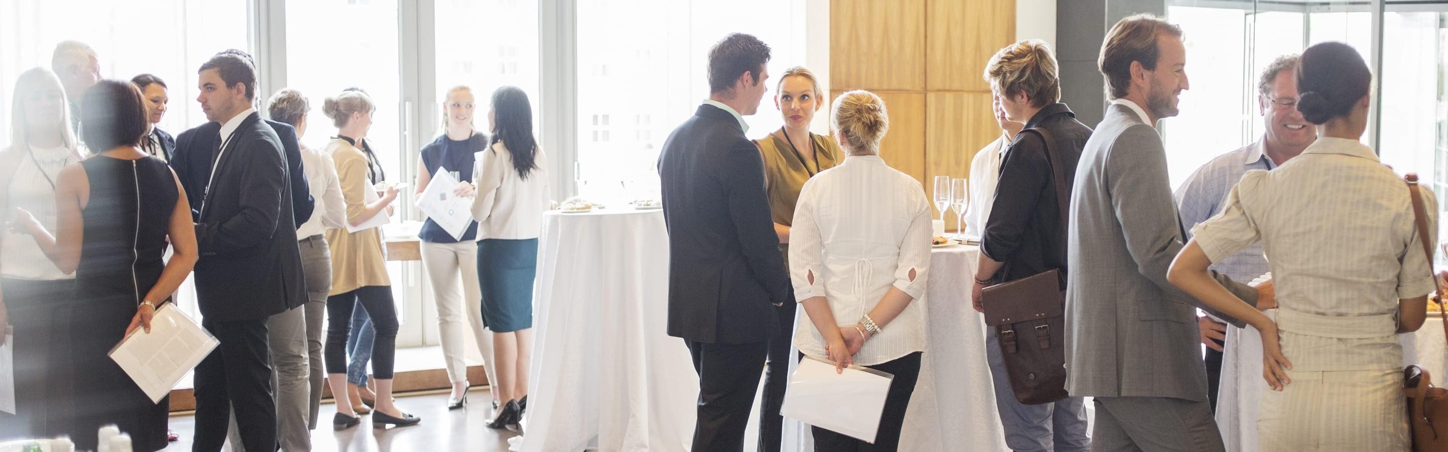 Male and female employees networking in an open space