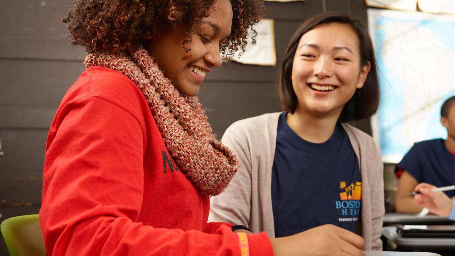 (slide 7 of 7) Image of teen and volunteer working at the Boston Higher Education Resource Center . 