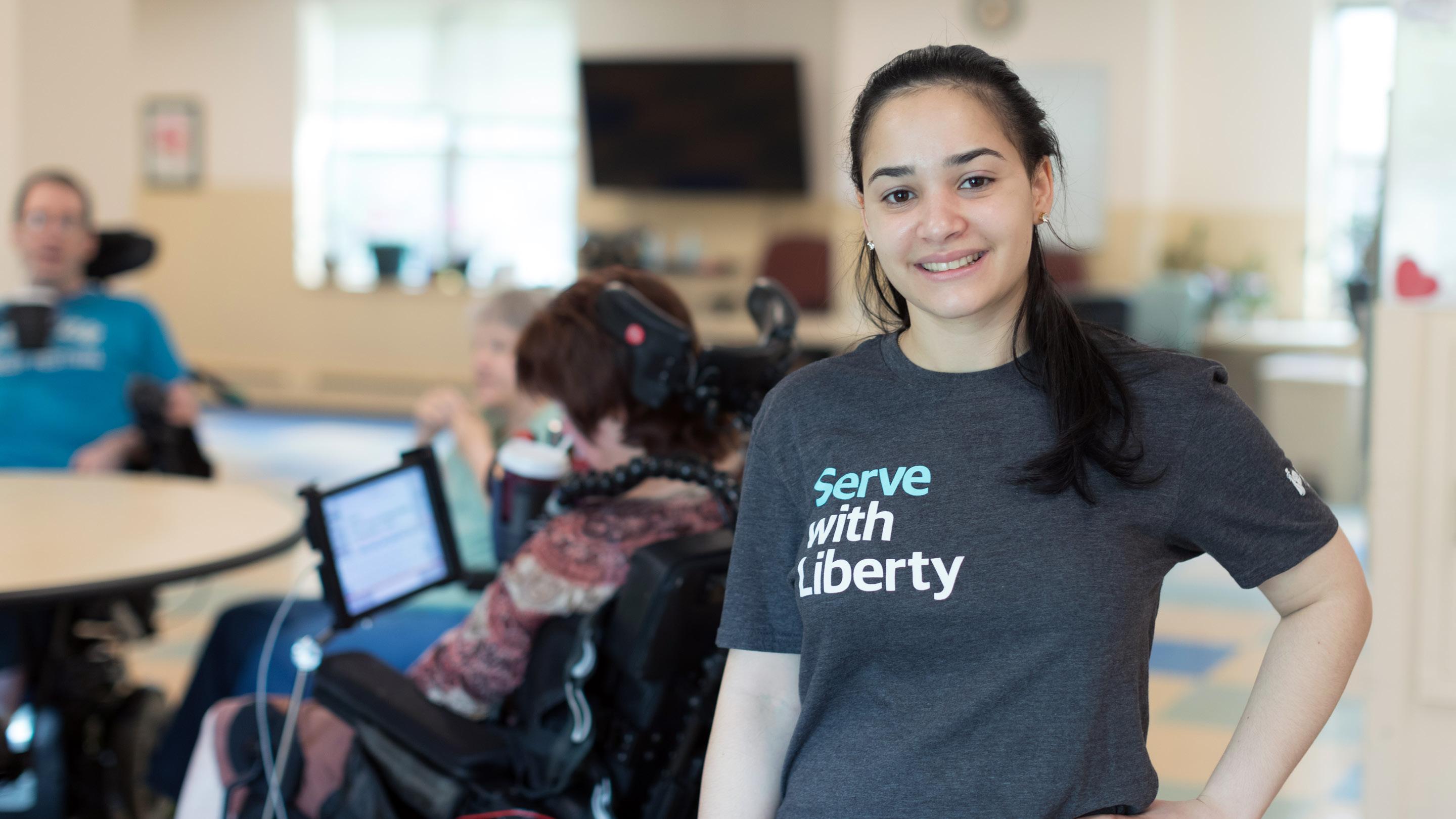 (slide 6 of 6) Liberty employee in Serve with Liberty shirt. 