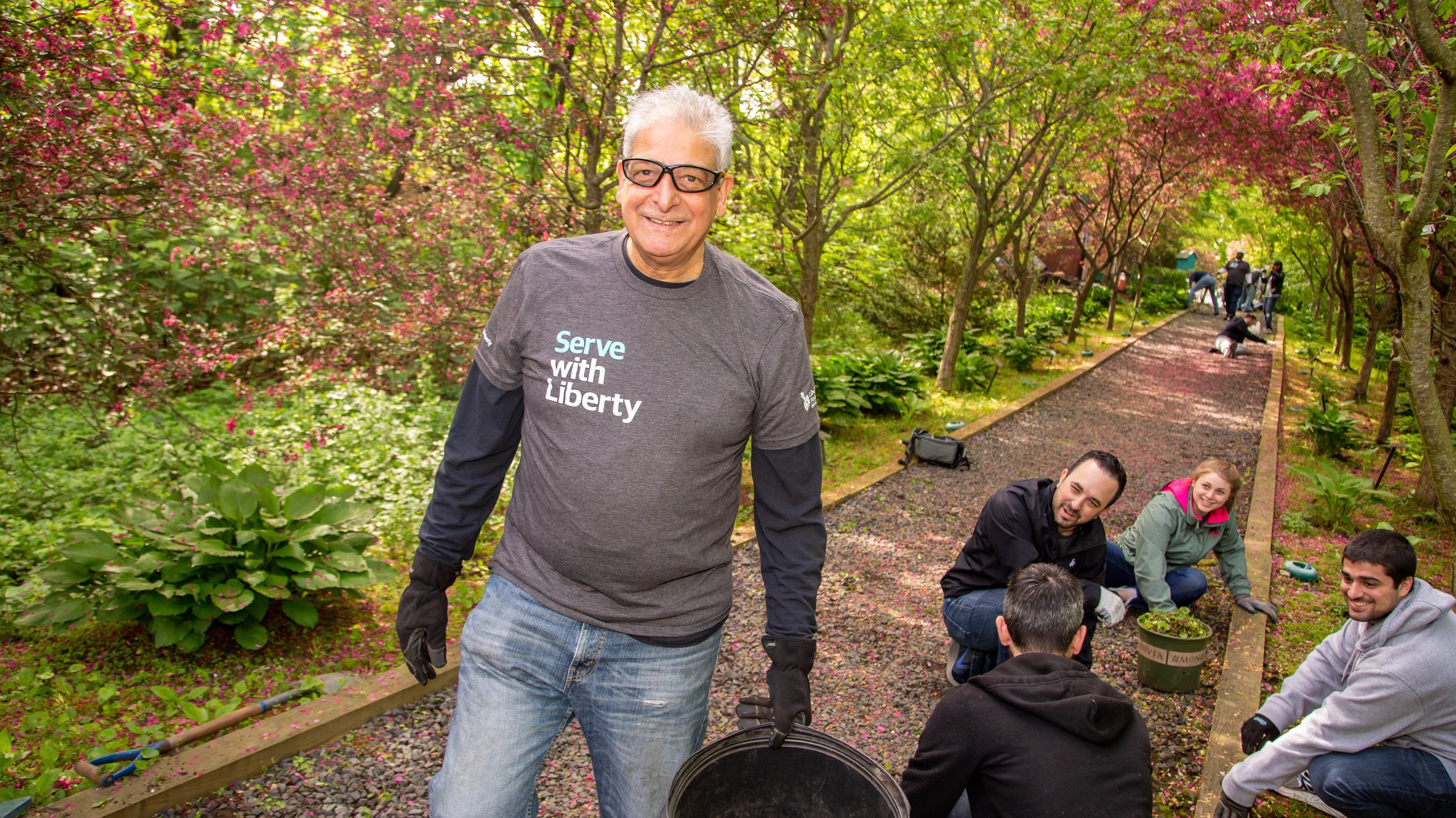 (slide 3 of 6) Liberty Mutual volunteer in Serve with Liberty shirt. 