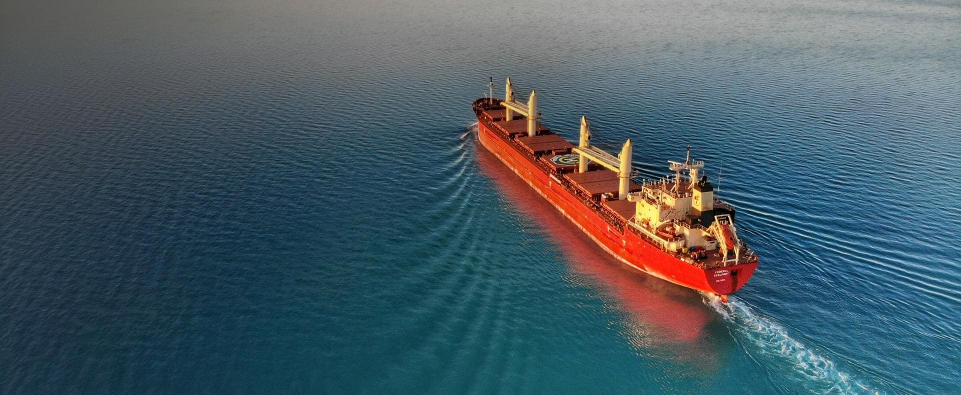 Freight Ship sailing in calm Ocean Waters