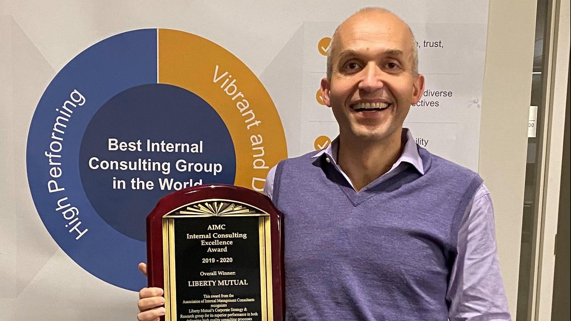 (slide 1 of 4) Alfredo Sciascia holding 2020 AIMC Award . 