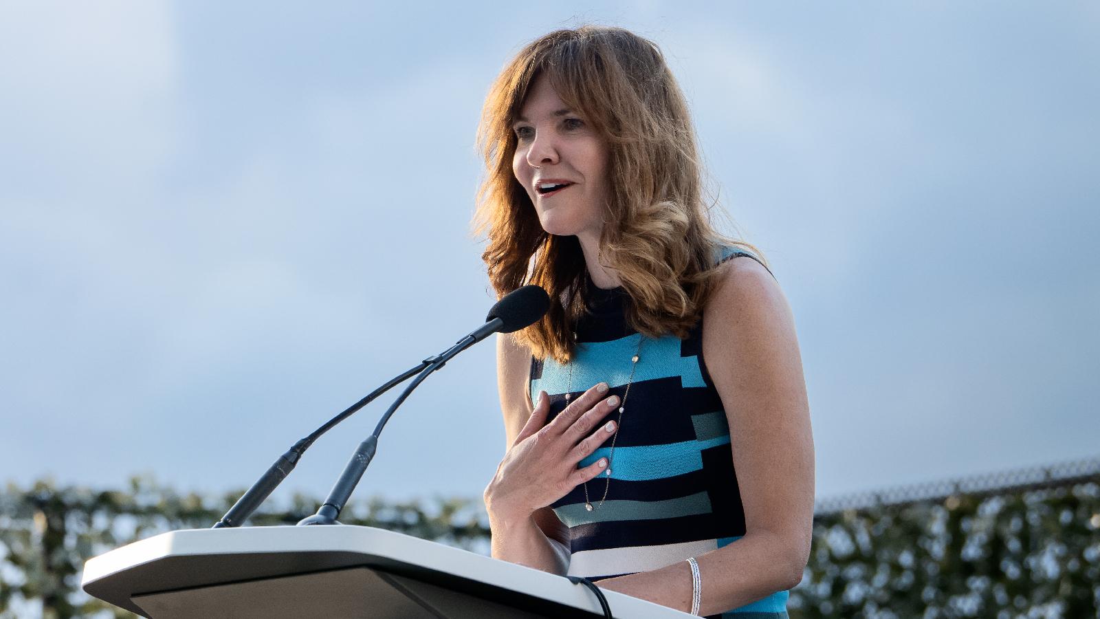 Melissa Macdonell of Liberty Mutual speaking at podium 