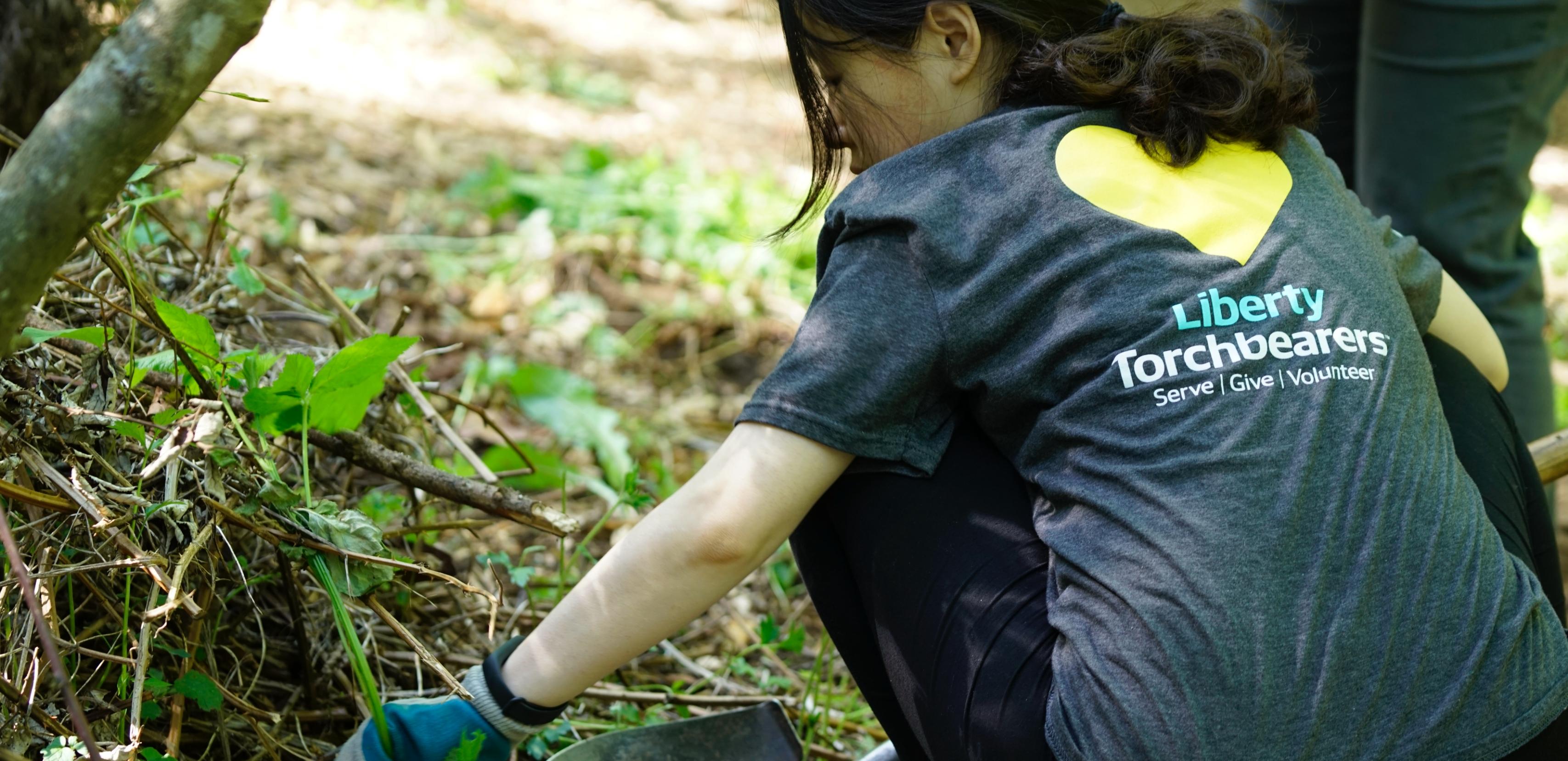 Liberty Mutual gardening outdoors as part of Serve with Liberty - a volunteer day program