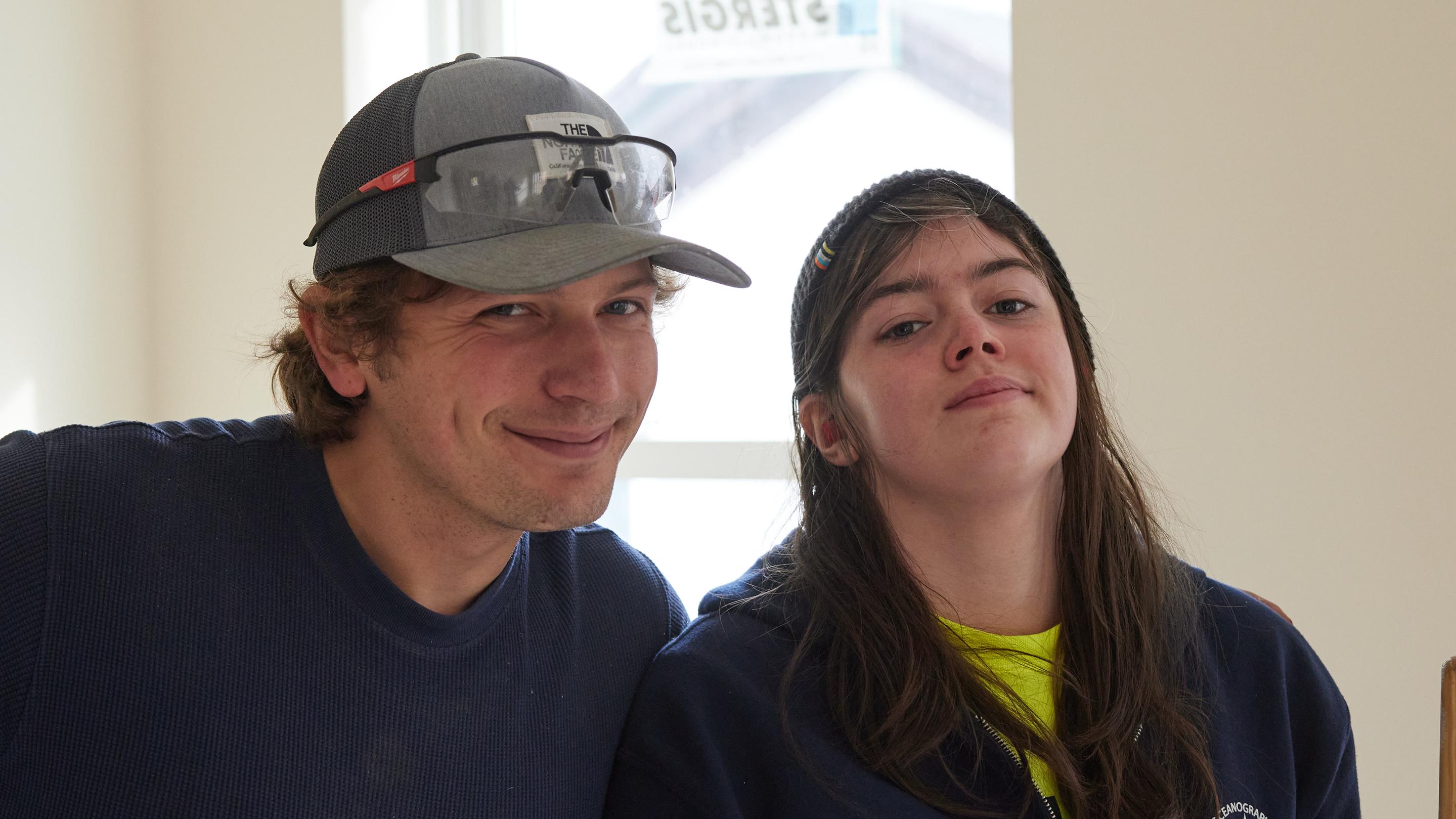 (slide 2 of 7) A young man and woman smiling to camera. 