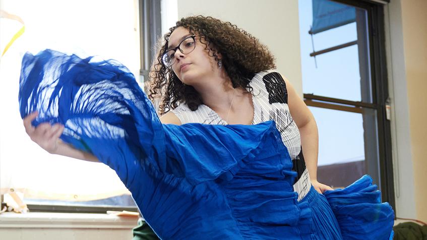 Teen in a blue skirt dancing