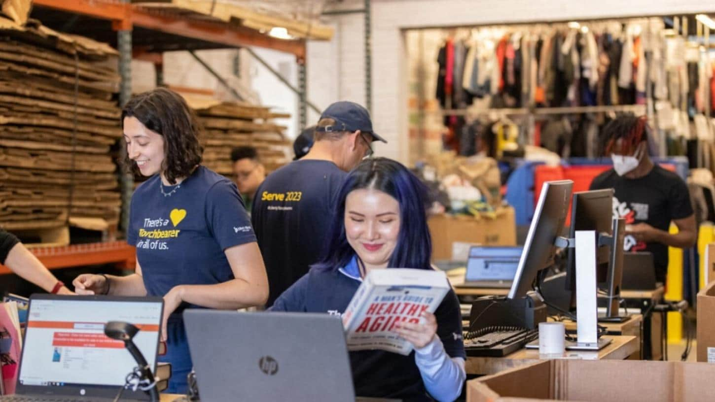 A group of Liberty employees volunteering, cataloging books and items