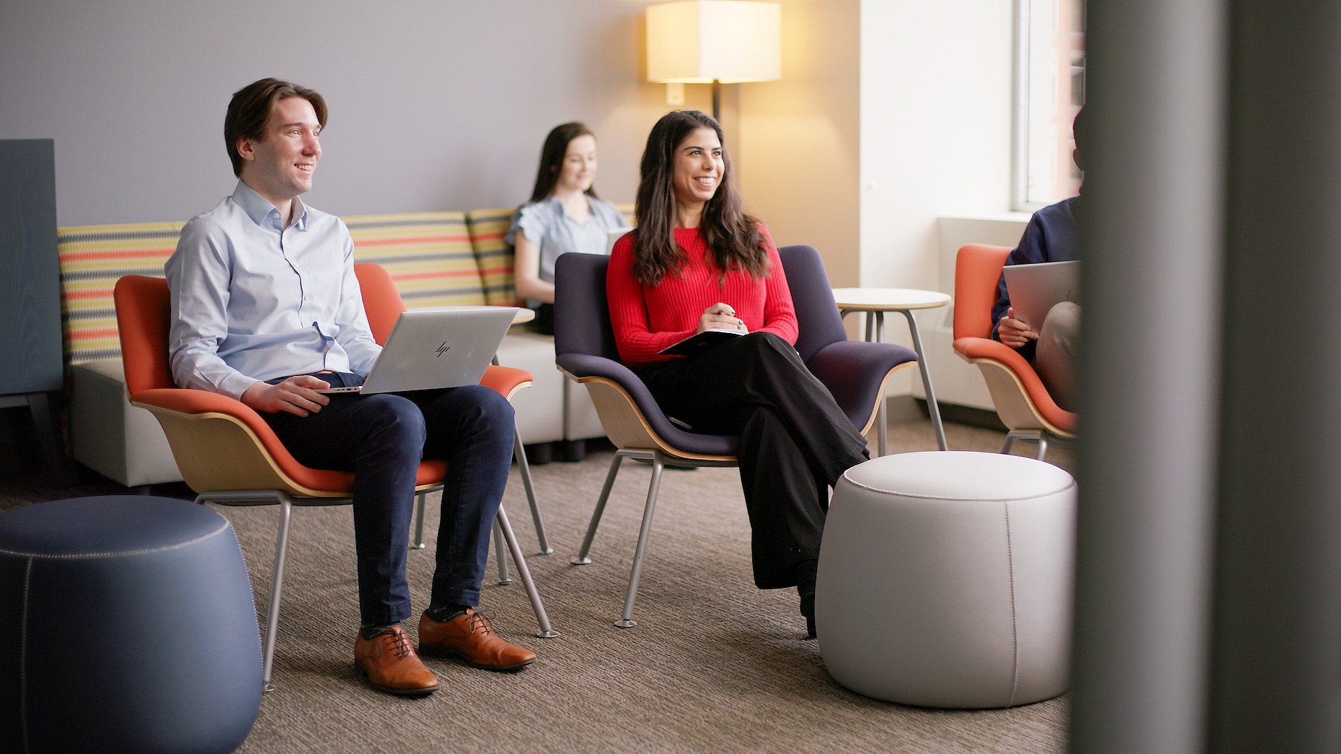 Group of people sitting and smiling in a meeting