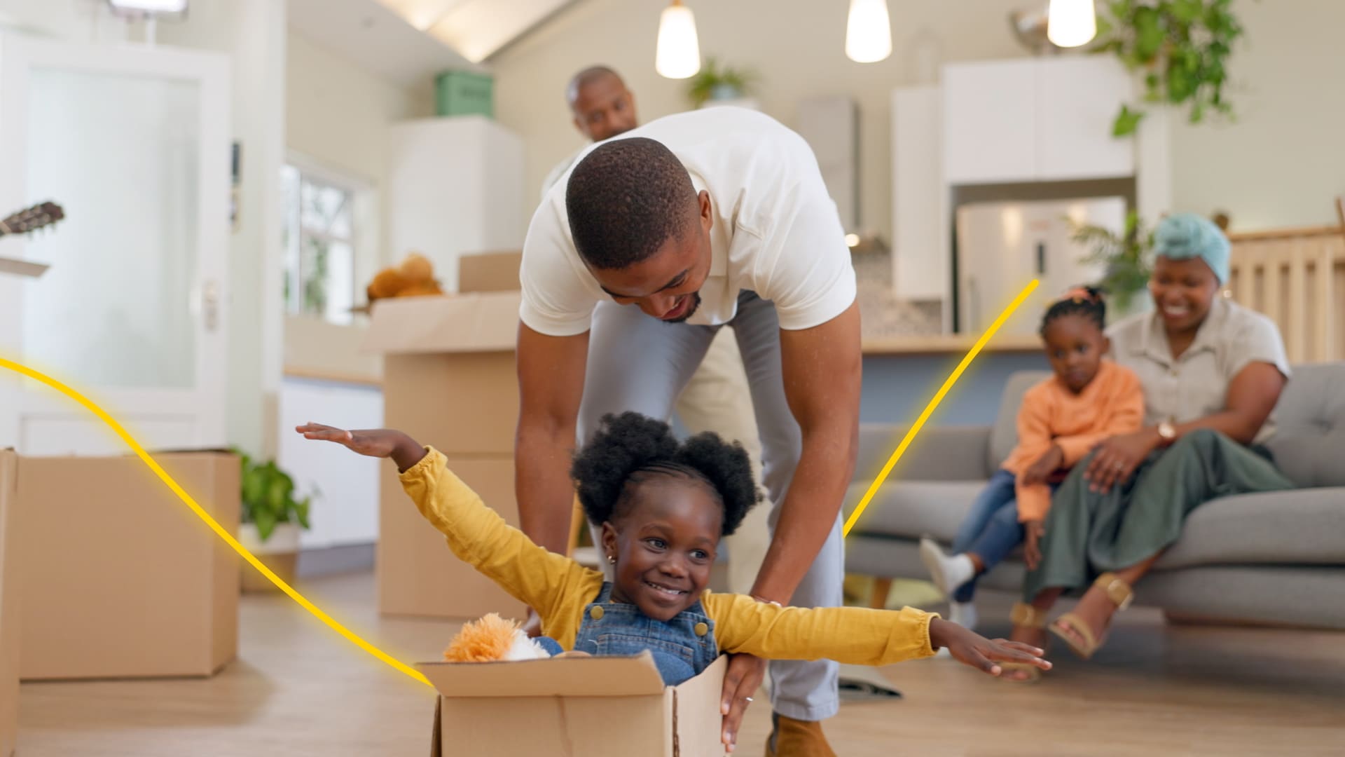 A father and child playing with boxes as they move into their new home