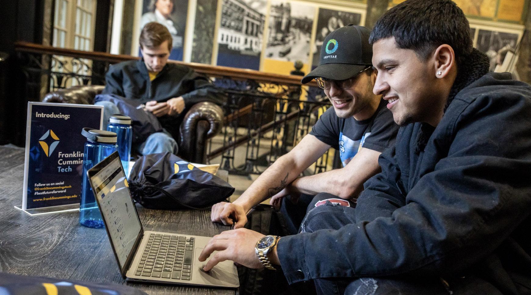 A group of students working on a laptop at Franklin Cummings