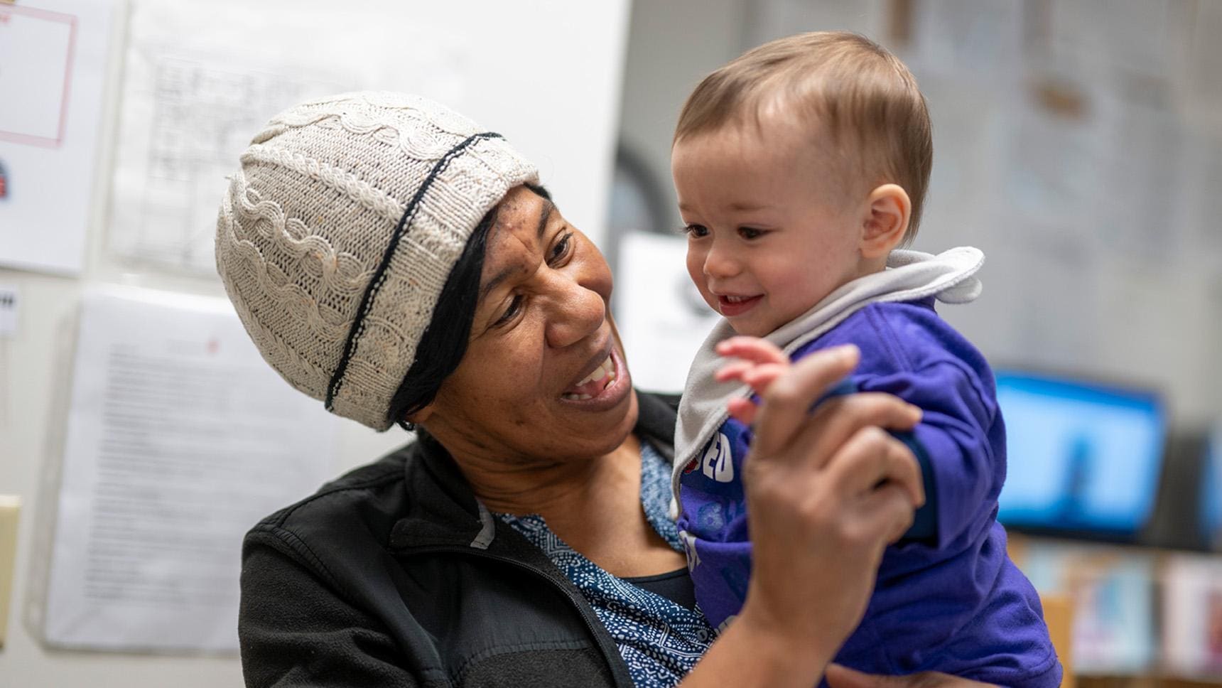 Volunteer with Liberty - a woman holding a baby
