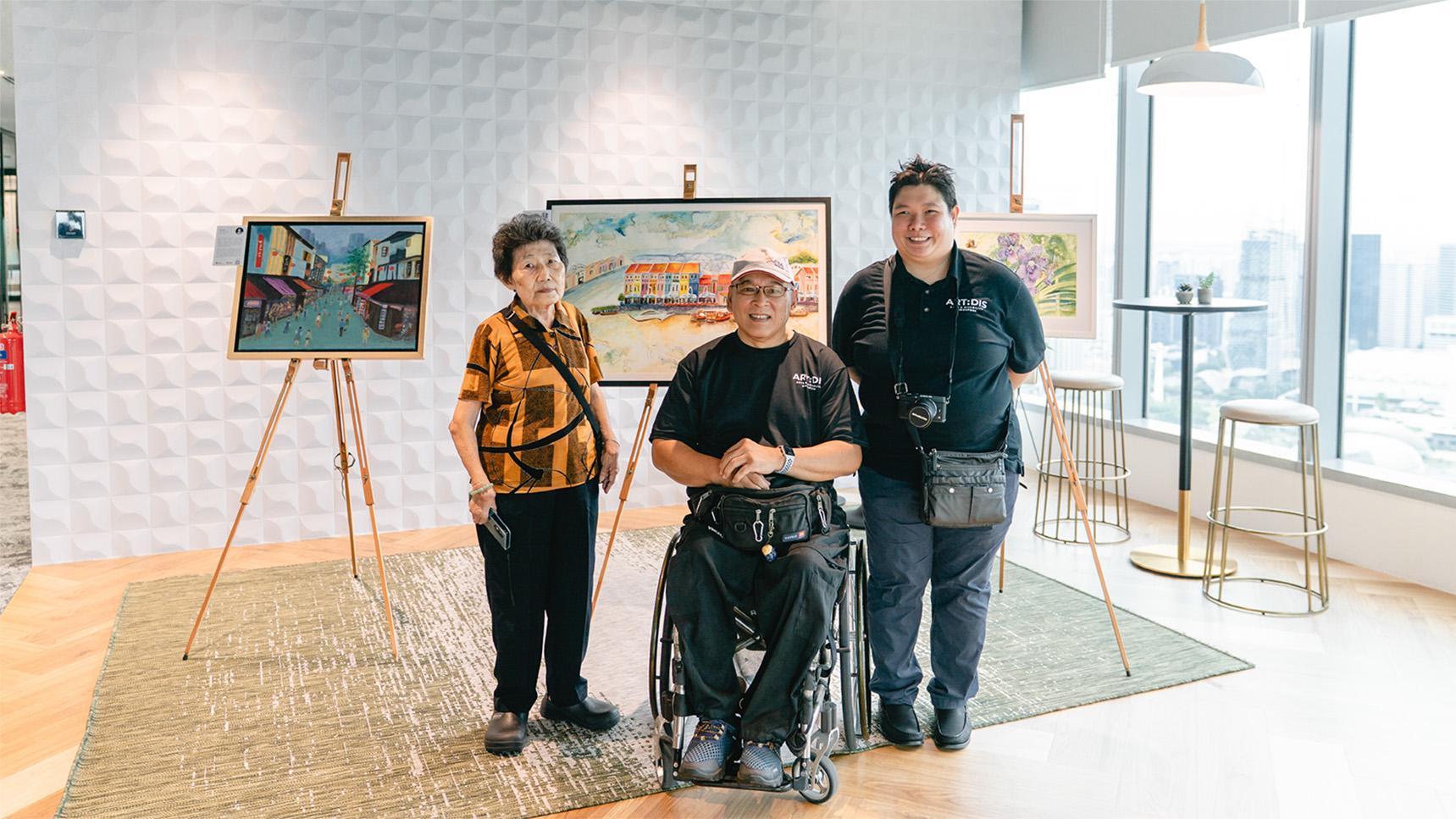 (slide 2 of 4) A group of artists standing in front of their artwork. 