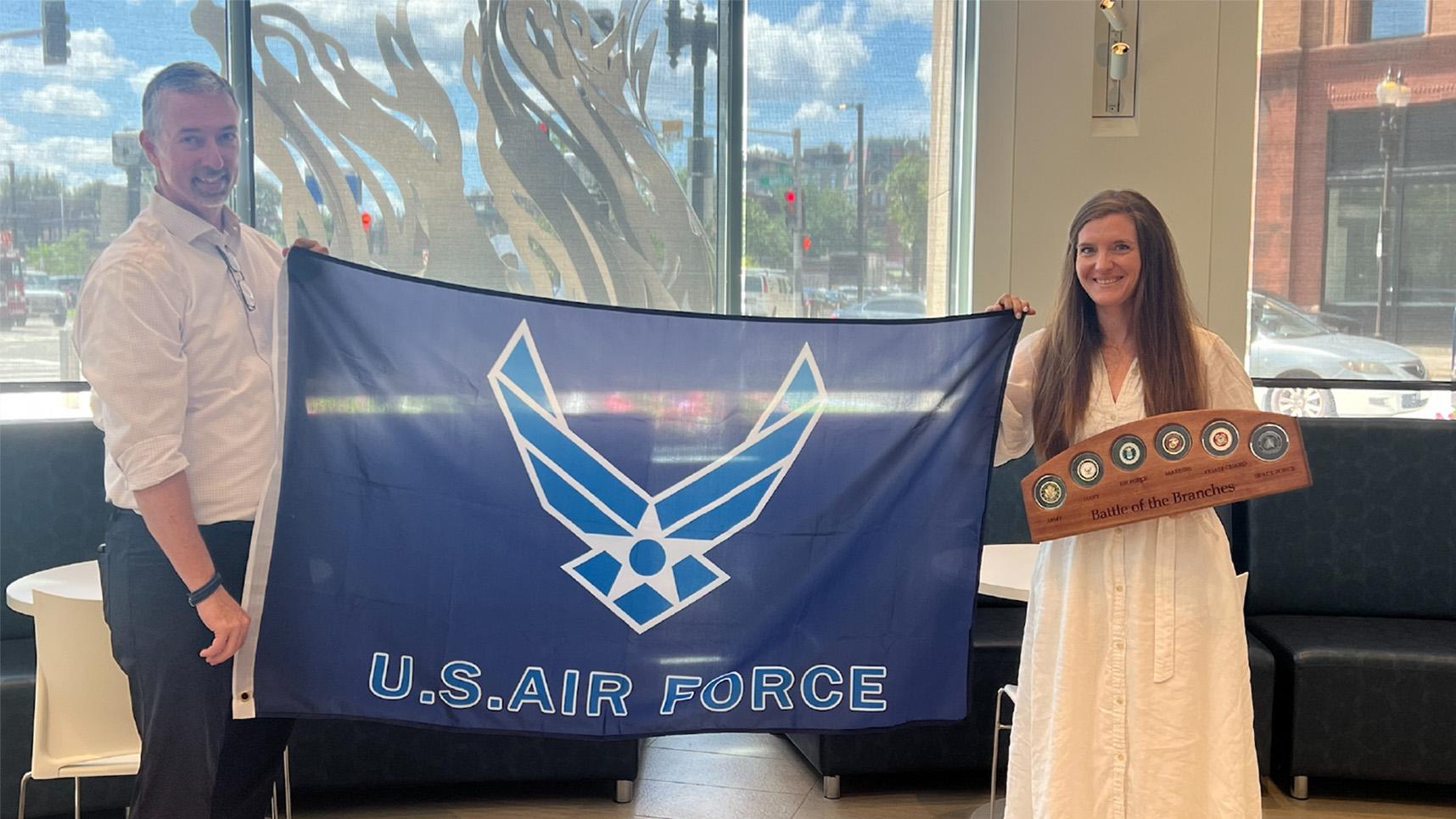 Image of two Valor Volunteers with the US Air Force Flag