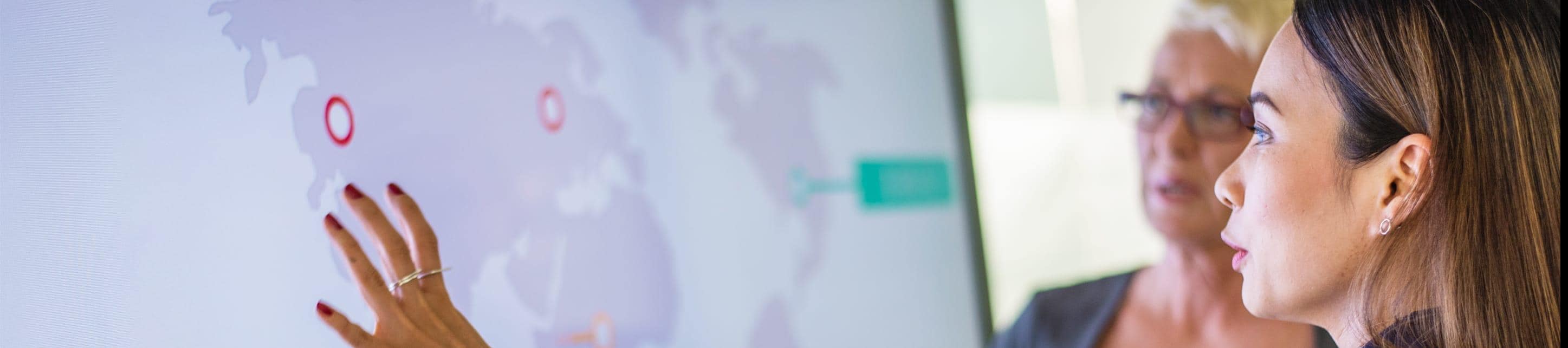 A close up of Two women analyzing a map