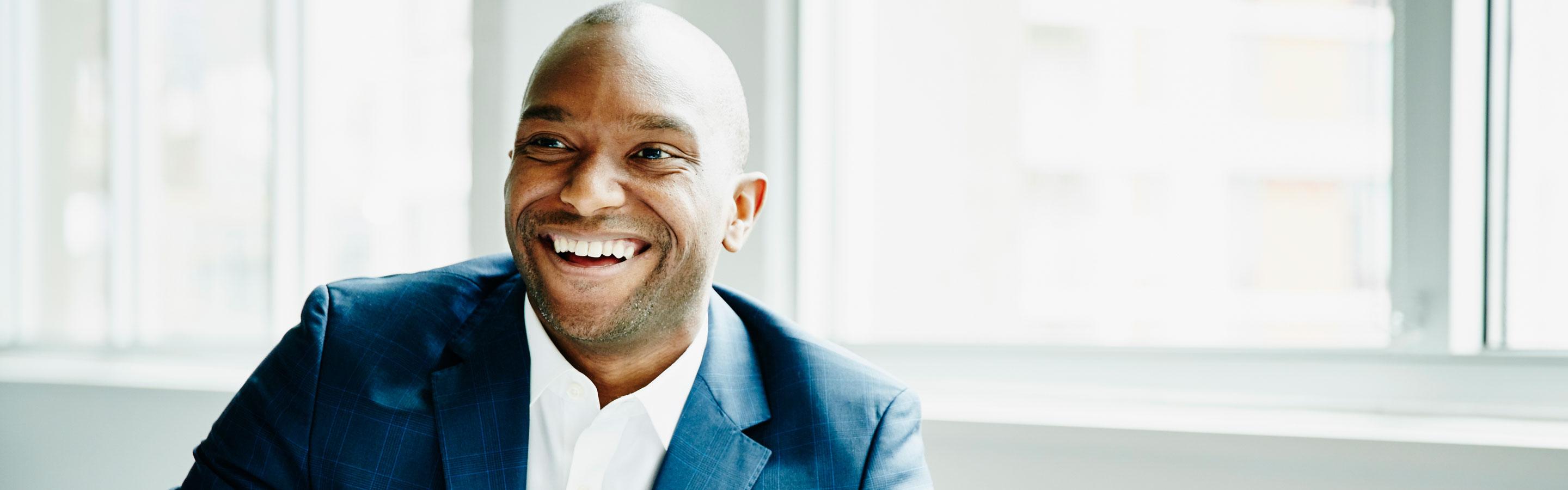 Male employee smiling to camera in a work setting