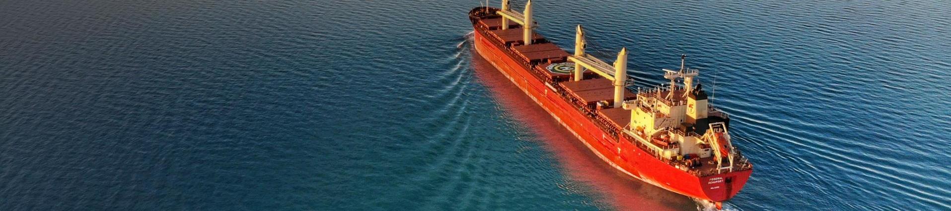 Freight Ship sailing in calm Ocean Waters