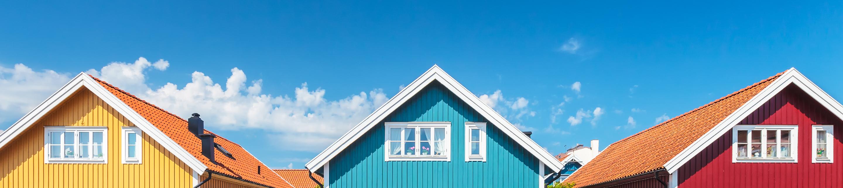 Exterior shot of a line of homes in primary colors
