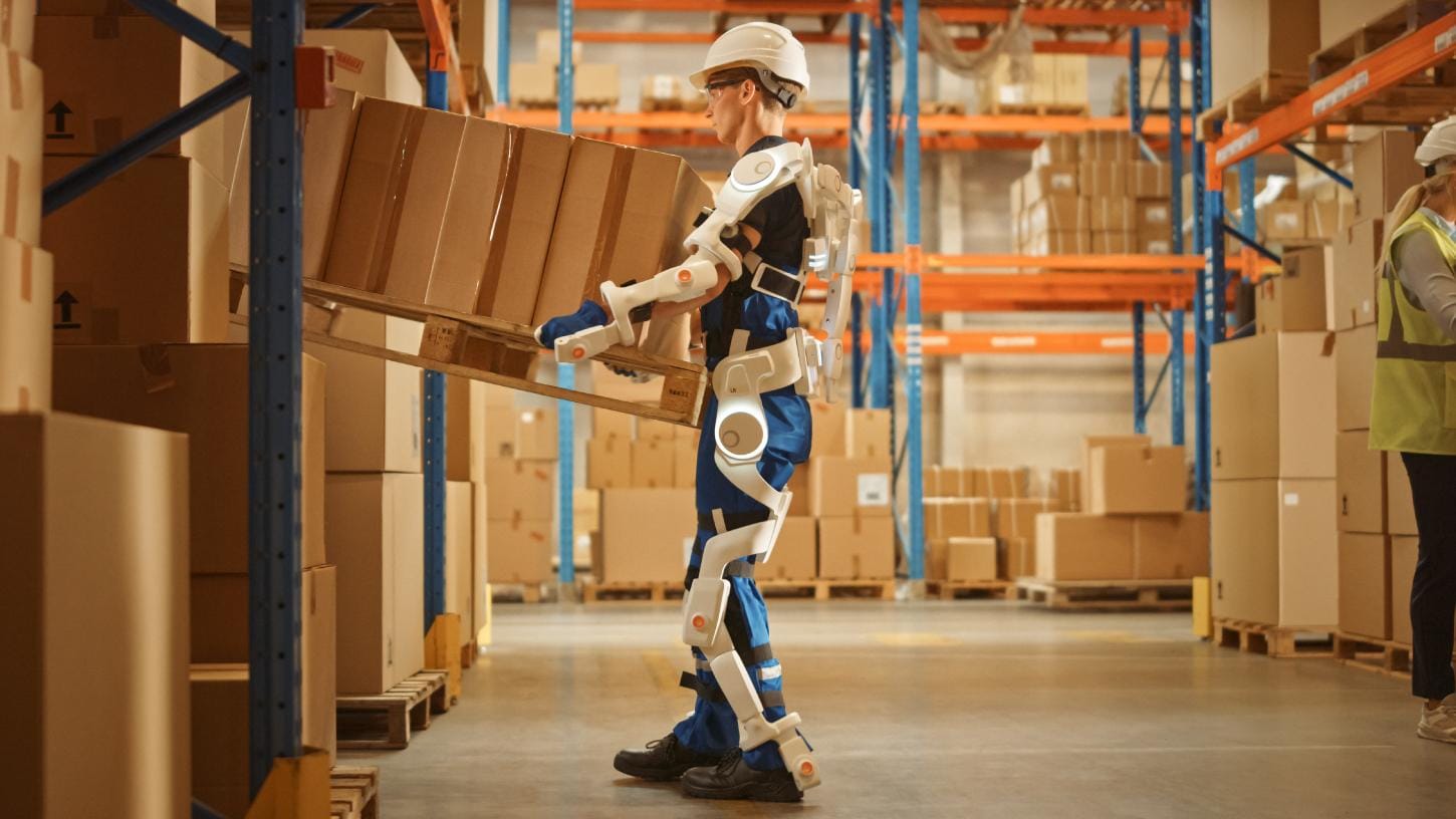 A worker in a warehouse using technology to lift and move stock