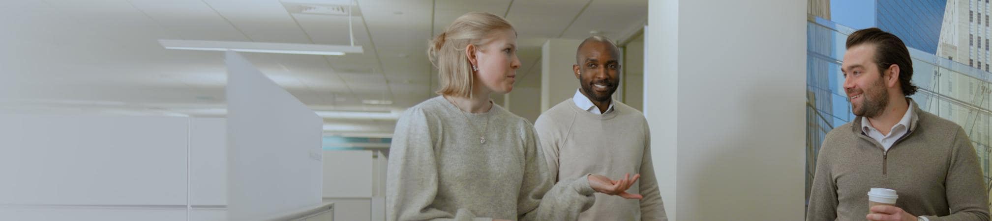 Group of colleagues chatting in an office setting