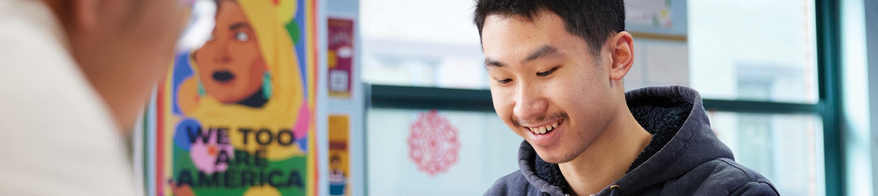 A student smiling down at his work
